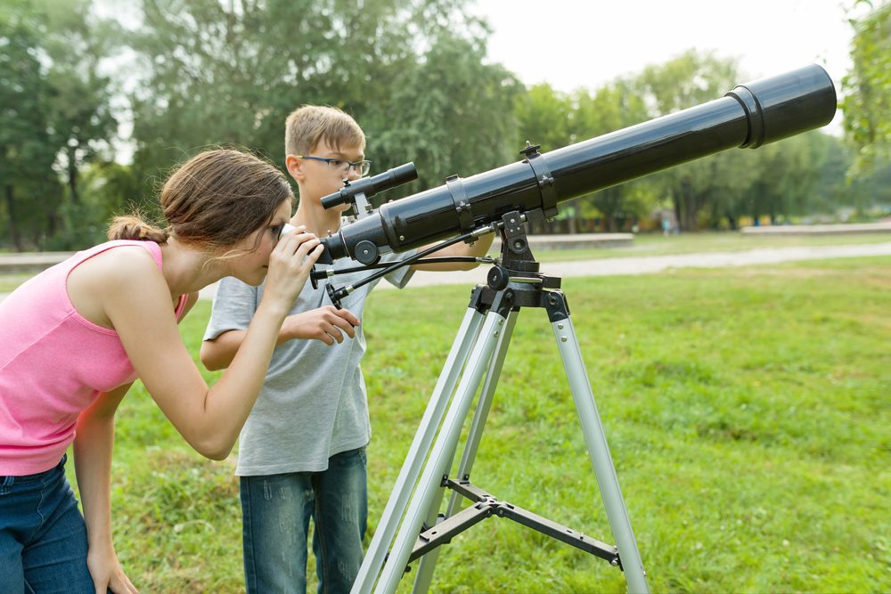 Children teenagers with telescope
